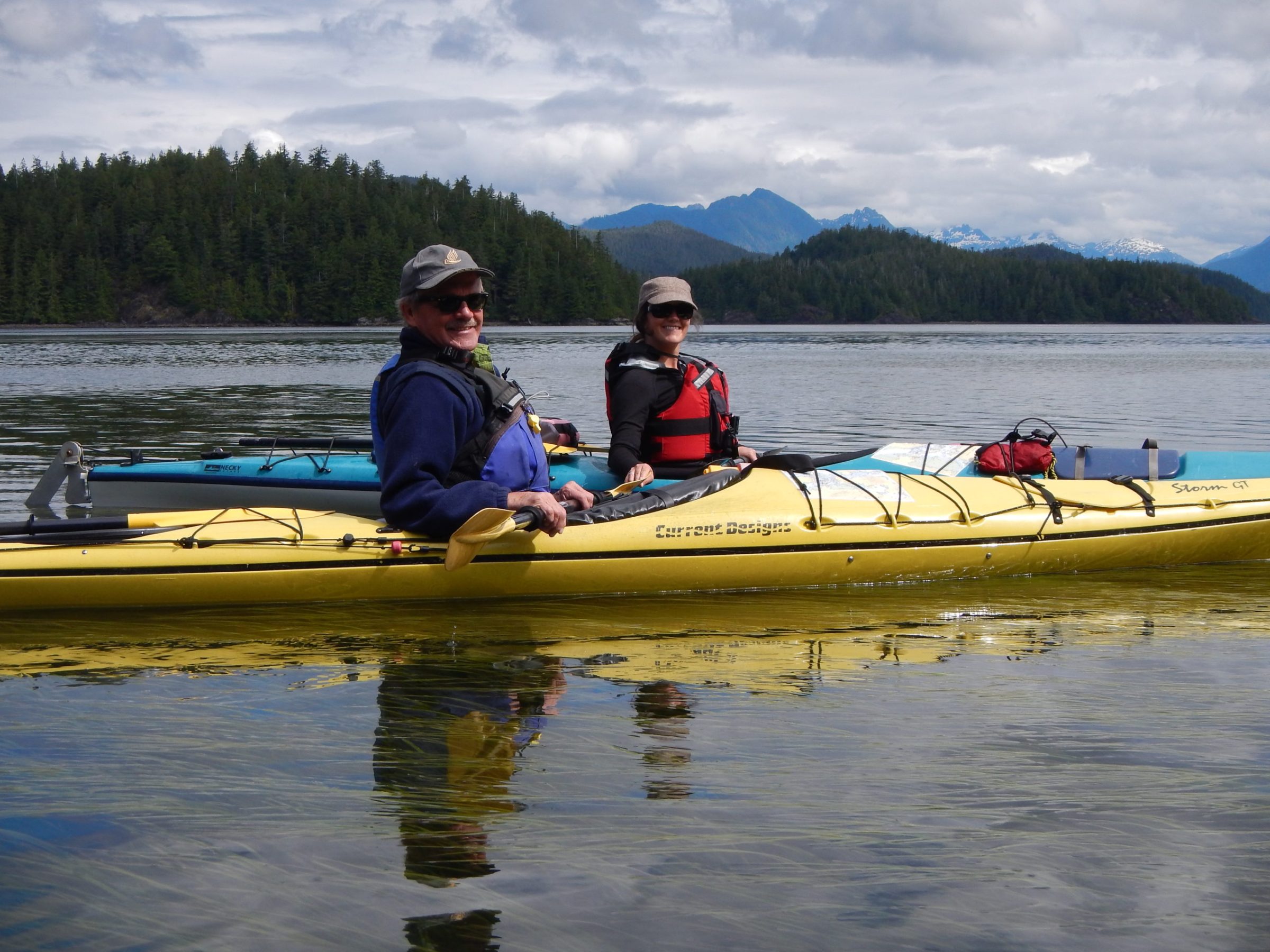 a group of people rowing a boat in the water